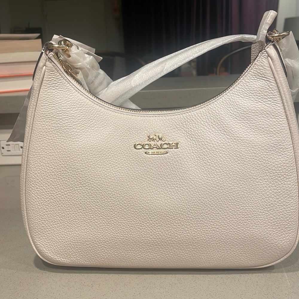 Never used. Brand new. Tags still on. Cream colored Coach purse